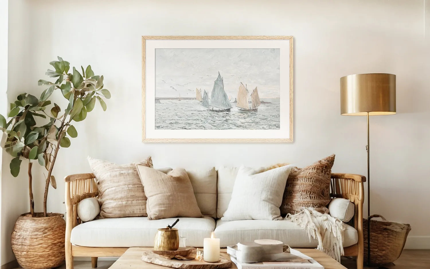 bright earthy beach coastal cottage living room with coastal wall art of sailboats at sea in an old-masters impressionist style painting above the couch